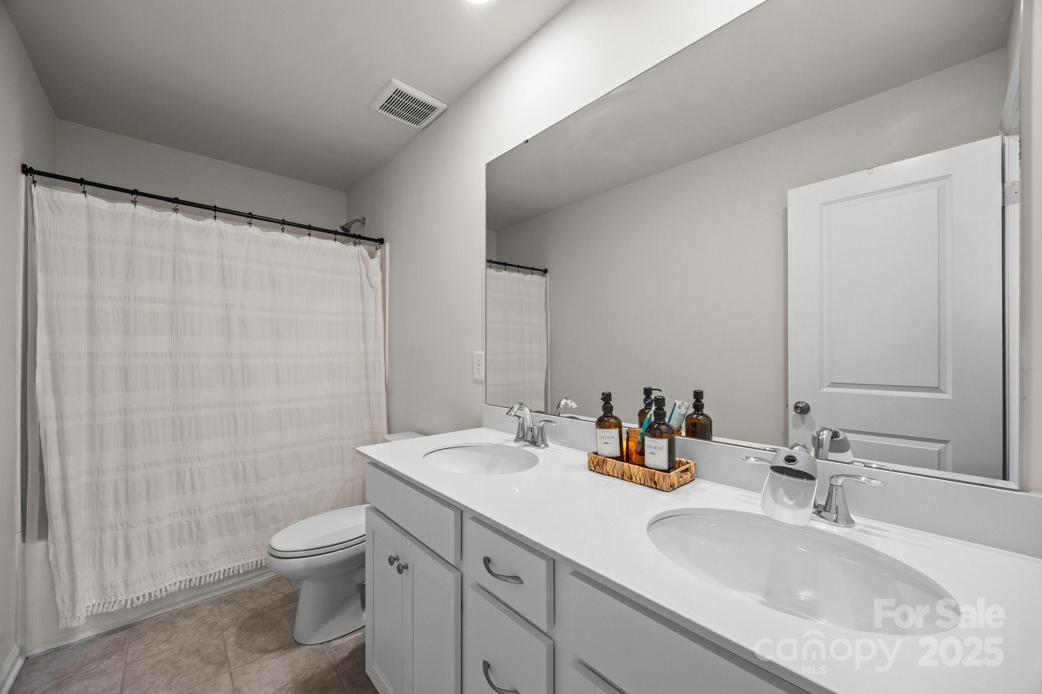 3643 Slider Terrace Lancaster, SC 29720 - Photo 21 of 46 a bathroom with double vanity sink toilet and shower