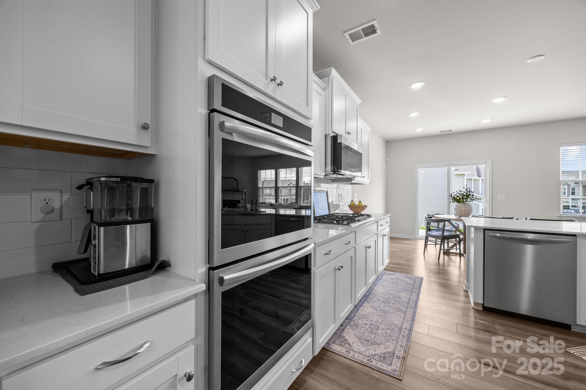 3643 Slider Terrace Lancaster, SC 29720 - Photo 22 of 46 a kitchen with stainless steel appliances kitchen island wooden cabinets and granite counter tops