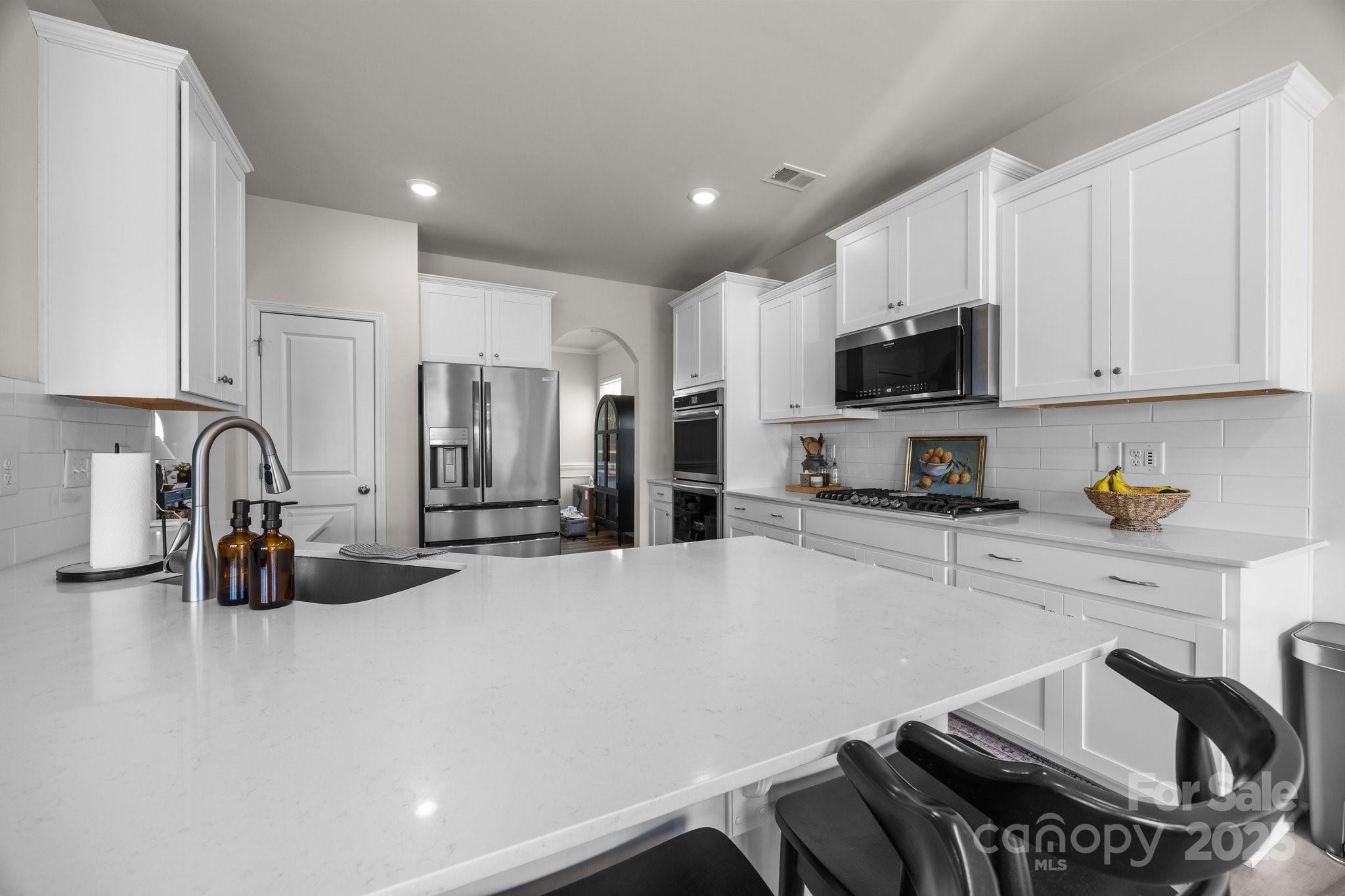 3643 Slider Terrace Lancaster, SC 29720 - Photo 6 of 46 a kitchen with stainless steel appliances a stove a sink a refrigerator a stove a microwave and cabinets