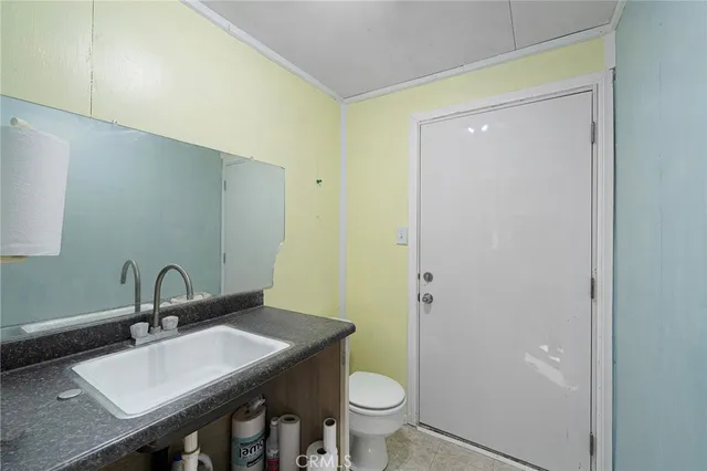 an aerial view of residential houses with outdoor space and parking