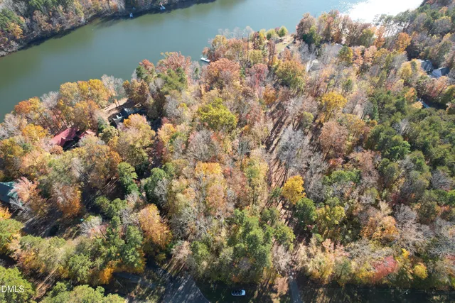 an aerial view of a houses with a lake