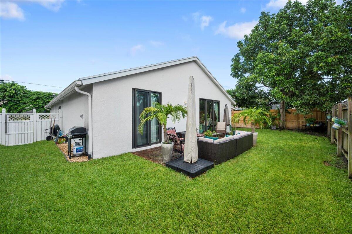 6430 Barbara Street Jupiter, FL 33458 - Photo 16 of 18 a view of a house with backyard and sitting area