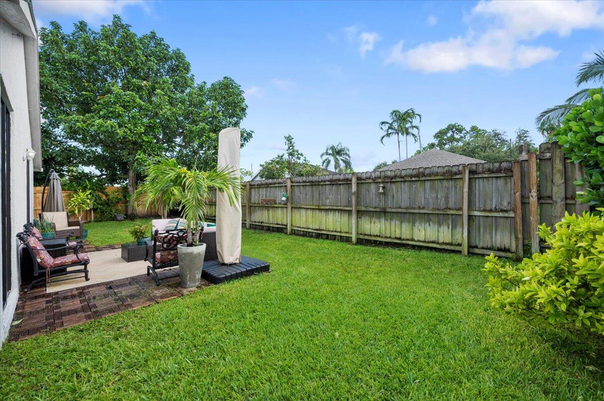 6430 Barbara Street Jupiter, FL 33458 - Photo 17 of 18 a view of a backyard with sitting area