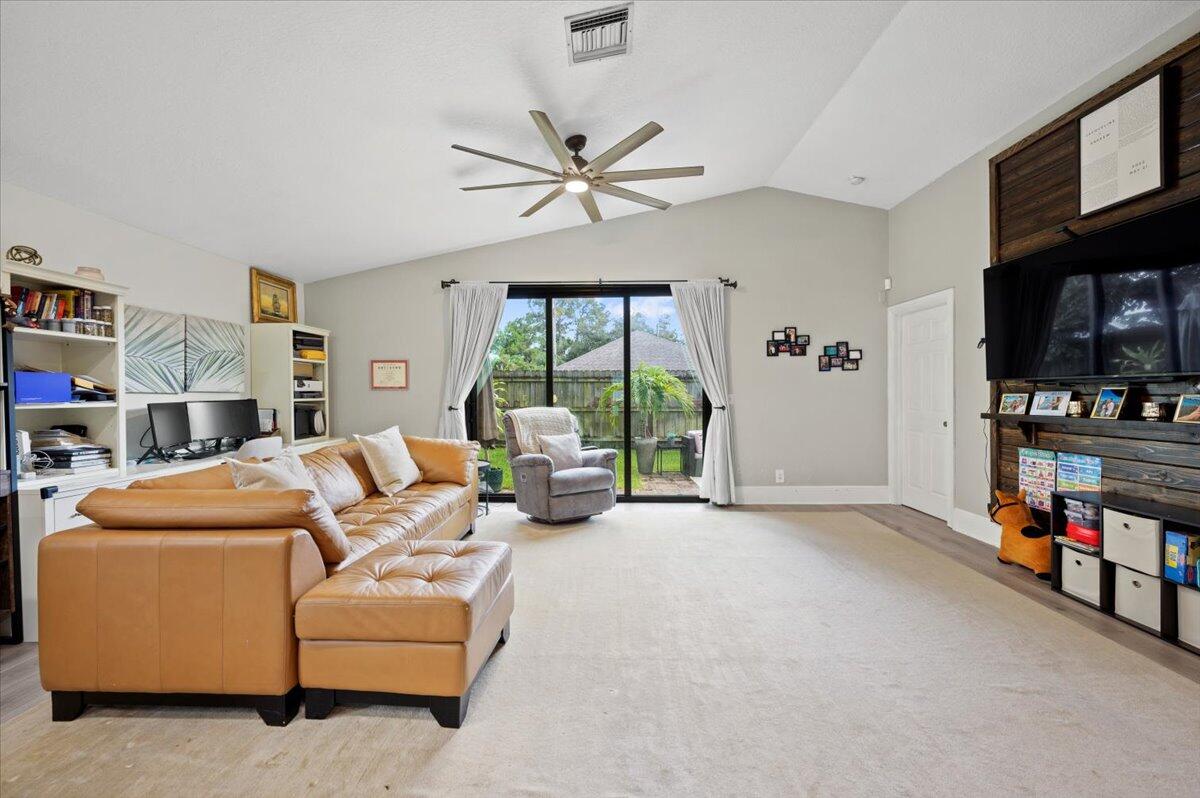 6430 Barbara Street Jupiter, FL 33458 - Photo 4 of 18 a living room with furniture and a flat screen tv
