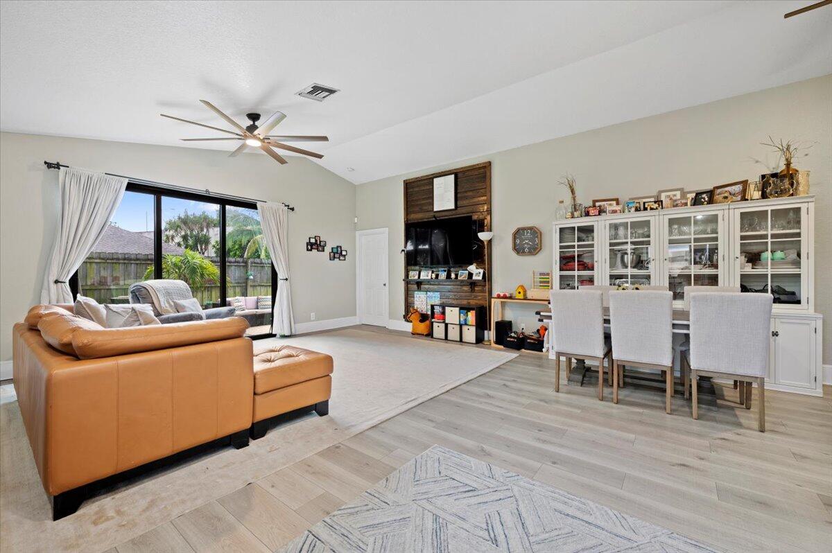 6430 Barbara Street Jupiter, FL 33458 - Photo 5 of 18 a living room with furniture and a flat screen tv