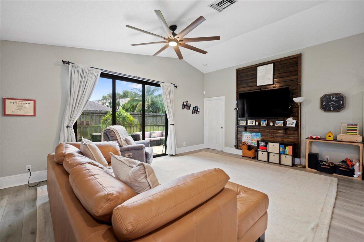 6430 Barbara Street Jupiter, FL 33458 - Photo 6 of 18 a living room with furniture and a flat screen tv