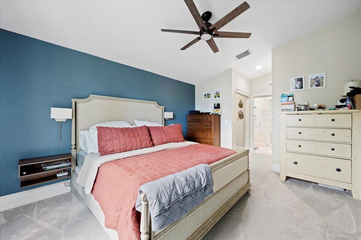 6430 Barbara Street Jupiter, FL 33458 - Photo 8 of 18 a bedroom with a bed and a ceiling fan