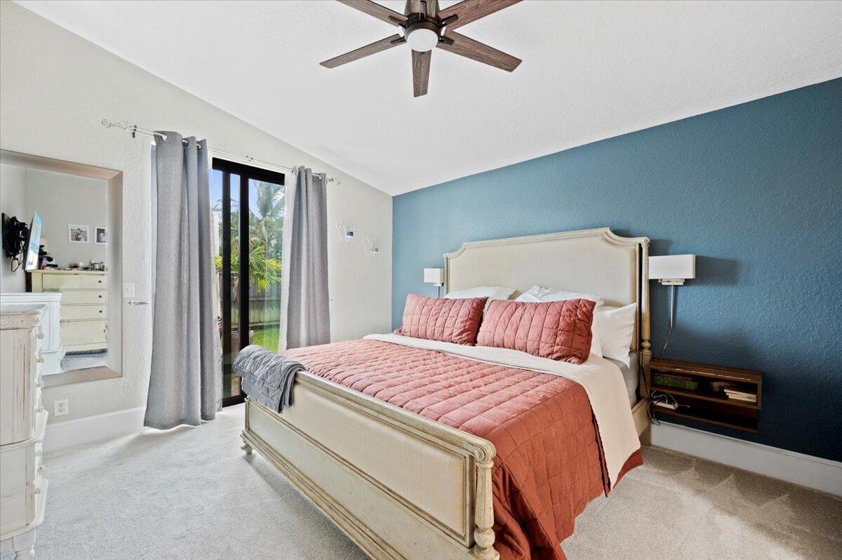 6430 Barbara Street Jupiter, FL 33458 - Photo 9 of 18 a bedroom with a bed and a ceiling fan