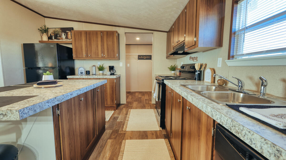 508 Sage Road Tahoka, TX 79373 - Photo 11 of 32 a kitchen with stainless steel appliances granite countertop a sink stove microwave refrigerator and wooden cabinets