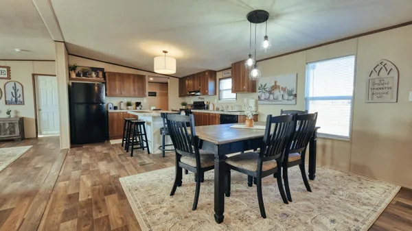 a dining room with furniture a chandelier and window