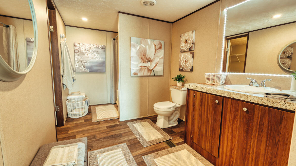 508 Sage Road Tahoka, TX 79373 - Photo 18 of 32 a bathroom with a sink a toilet and a large mirror
