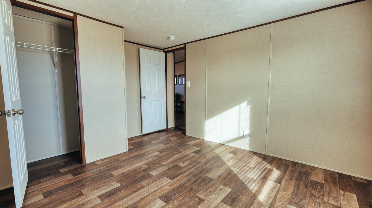 508 Sage Road Tahoka, TX 79373 - Photo 23 of 32 a view of an empty room with wooden floor and a window