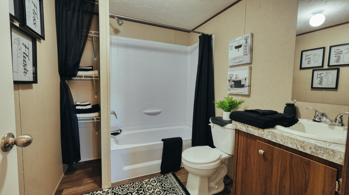 508 Sage Road Tahoka, TX 79373 - Photo 24 of 32 a bathroom with a granite countertop sink toilet and shower