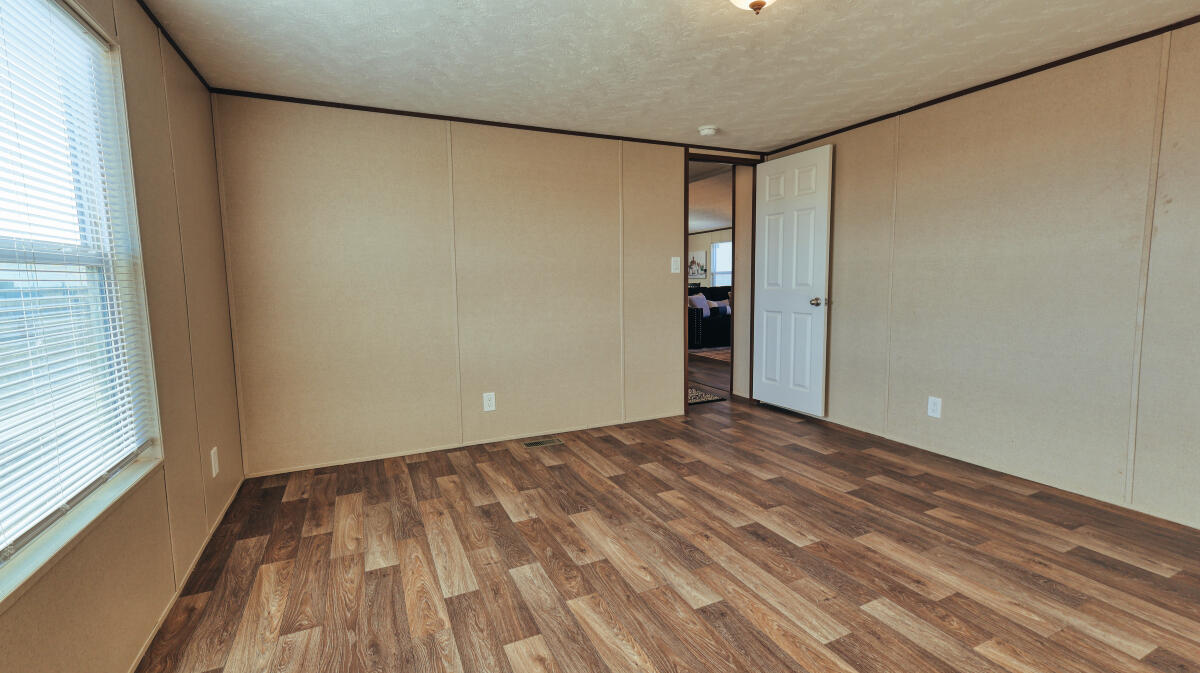 508 Sage Road Tahoka, TX 79373 - Photo 25 of 32 a view of empty room with wooden floor and fan