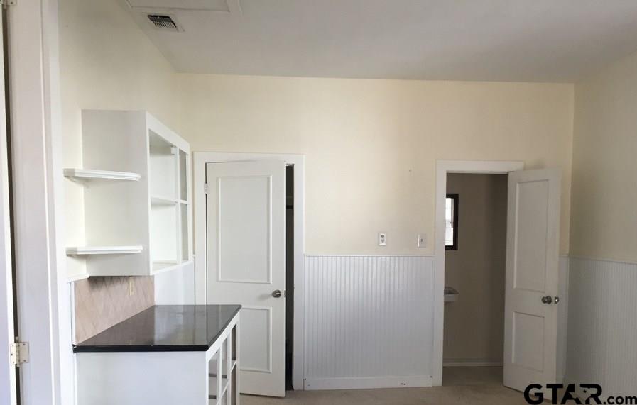 509 North Line Street Mineola, TX 75773 - Photo 12 of 16 a kitchen with stainless steel appliances a refrigerator and a sink