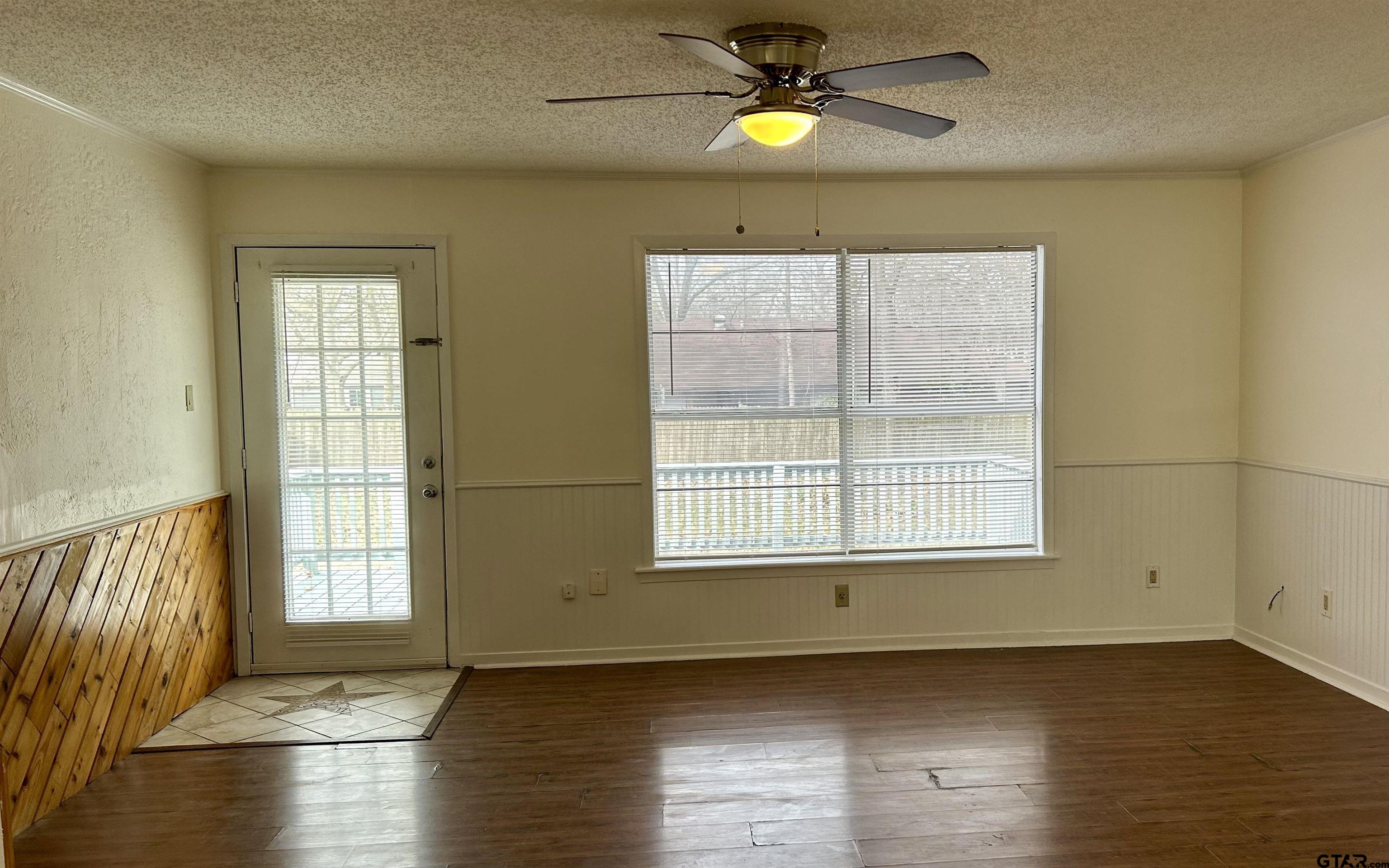 509 North Line Street Mineola, TX 75773 - Photo 6 of 16 an empty room with wooden floor and windows