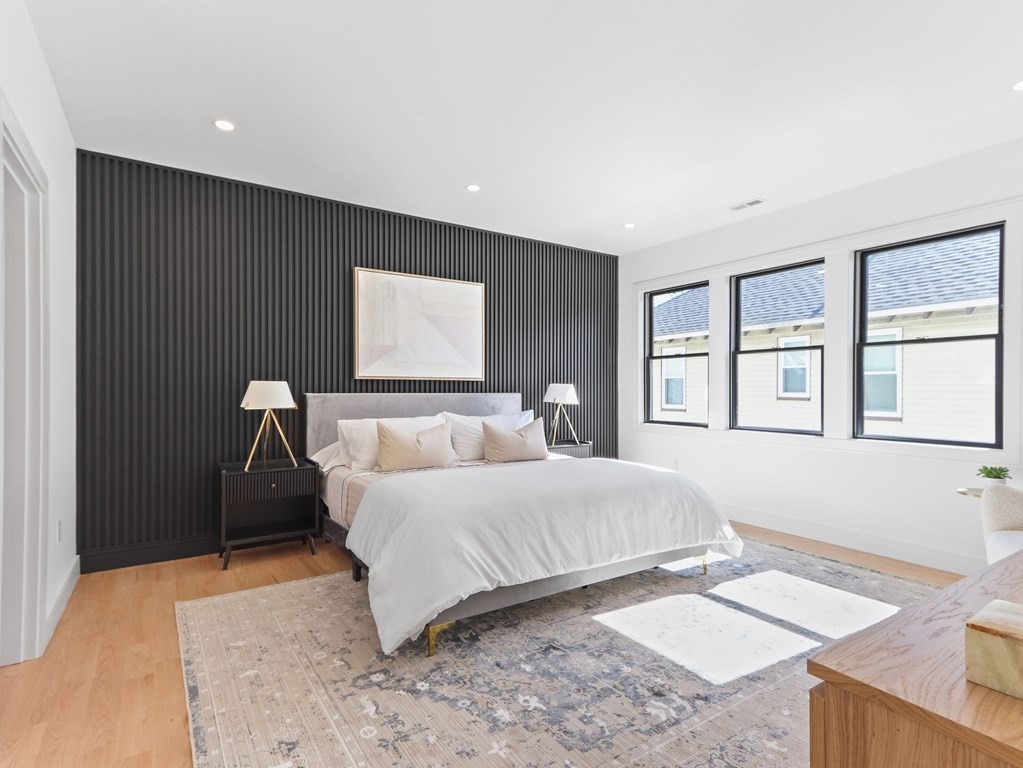 1917 Commonwealth Avenue, Unit 1917 Newton, MA 02466 - Photo 12 of 30 a bedroom with a bed and a large window