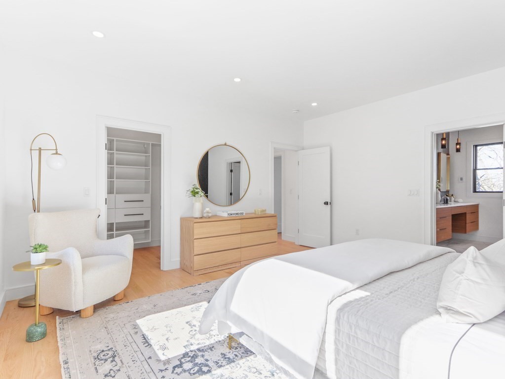 1917 Commonwealth Avenue, Unit 1917 Newton, MA 02466 - Photo 14 of 30 a bedroom with a bed and wooden floor