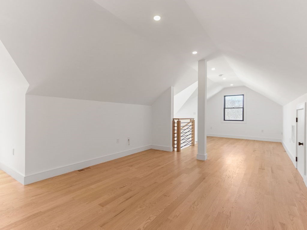 1917 Commonwealth Avenue, Unit 1917 Newton, MA 02466 - Photo 23 of 30 an empty room with wooden floor and windows