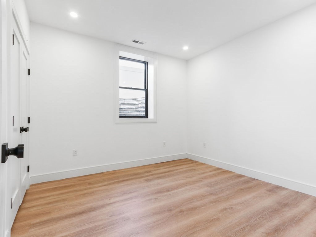 1917 Commonwealth Avenue, Unit 1917 Newton, MA 02466 - Photo 26 of 30 an empty room with wooden floor and windows
