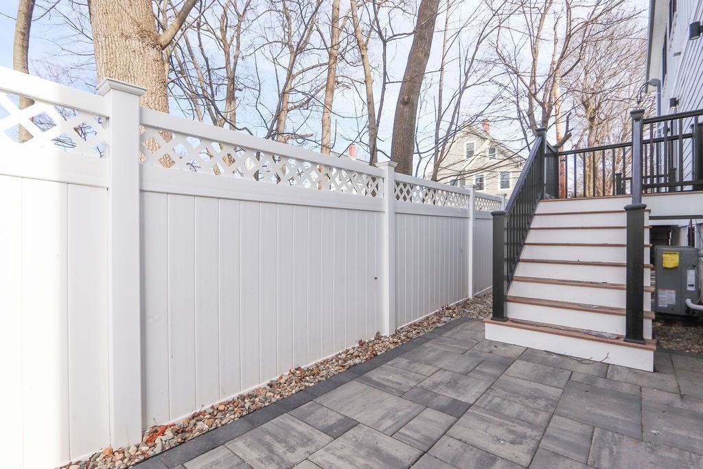 1917 Commonwealth Avenue, Unit 1917 Newton, MA 02466 - Photo 28 of 30 a view of a house with a yard and garage