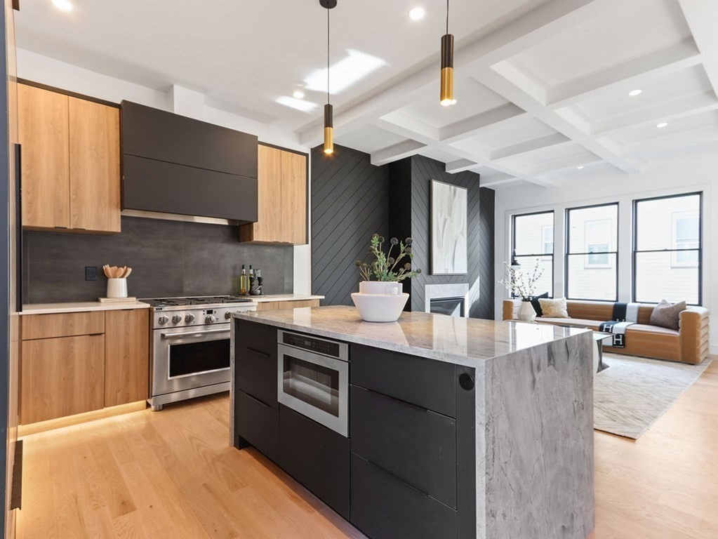 1917 Commonwealth Avenue, Unit 1917 Newton, MA 02466 - Photo 6 of 30 a large kitchen with stainless steel appliances granite countertop a stove and a sink dishwasher with cabinets