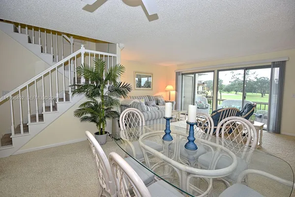 a dining room with furniture garden potted plants and wooden floor
