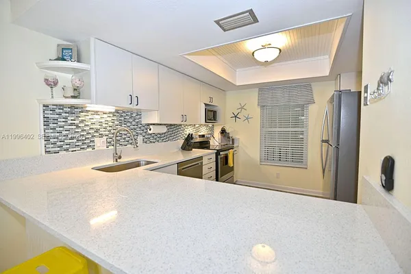 a kitchen with stainless steel appliances a sink a stove and a refrigerator