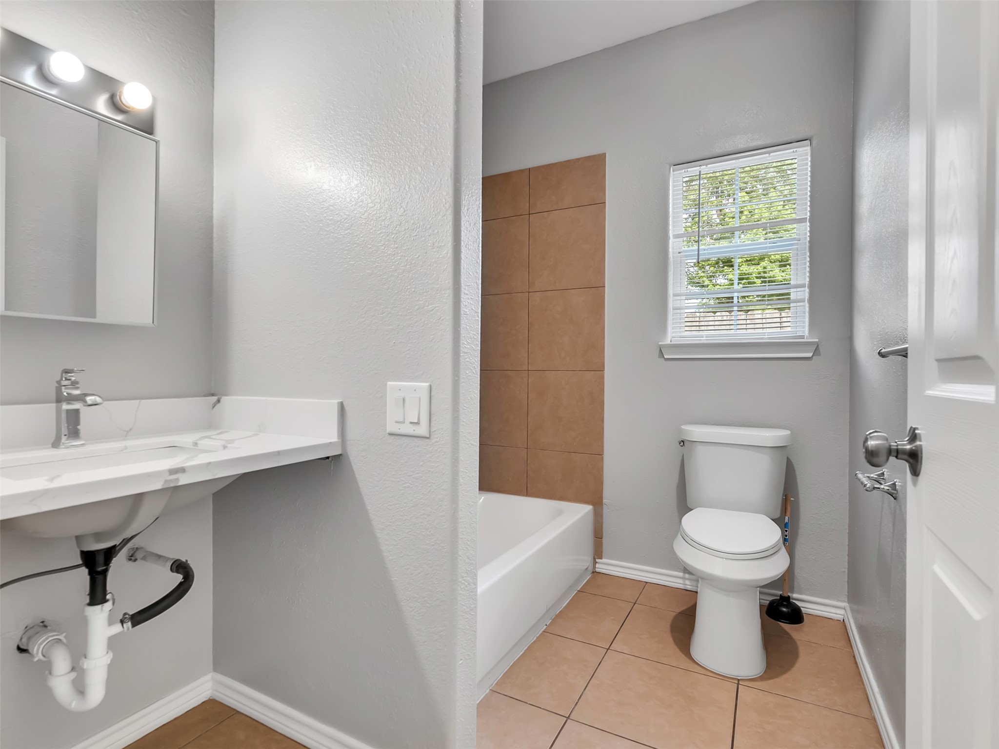 104 Longstreet Road, Unit 2 Willis, TX 77378 - Photo 20 of 26 a bathroom with a sink toilet and a bathtub