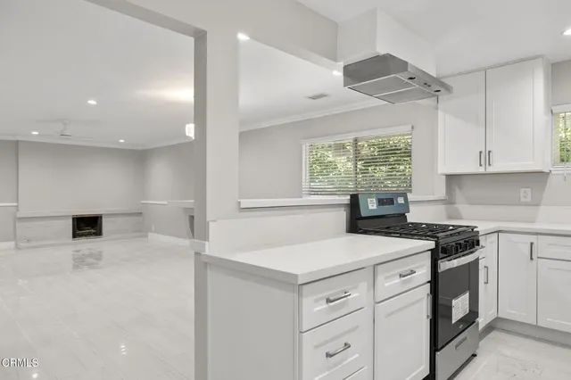 a kitchen that has a sink and a stove in it