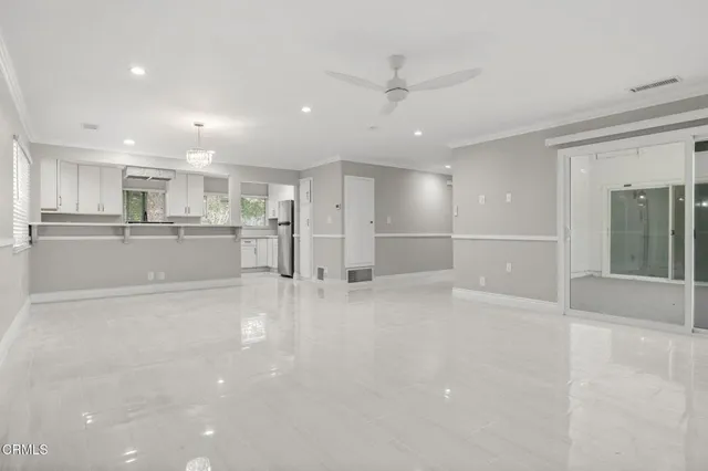 a view of large kitchen with large stainless steel appliances