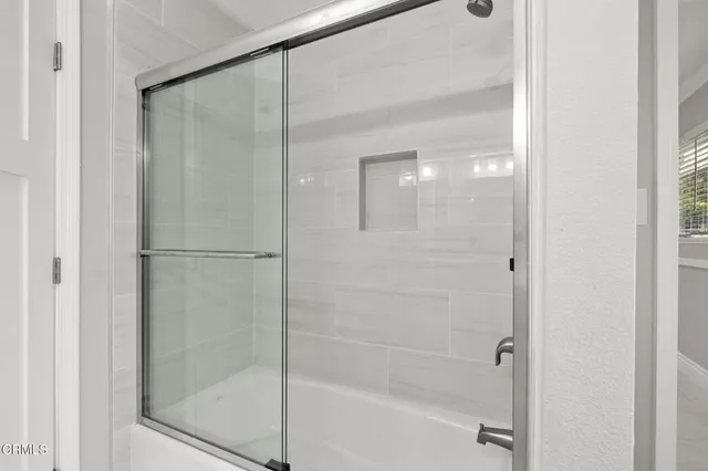 a bathroom with a glass shower door