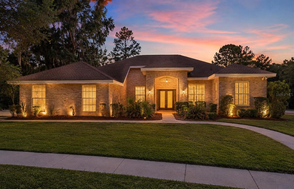 6153 New Osprey Point Weeki Wachee, FL 34607 - Photo 3 of 65 a front view of a house with a yard