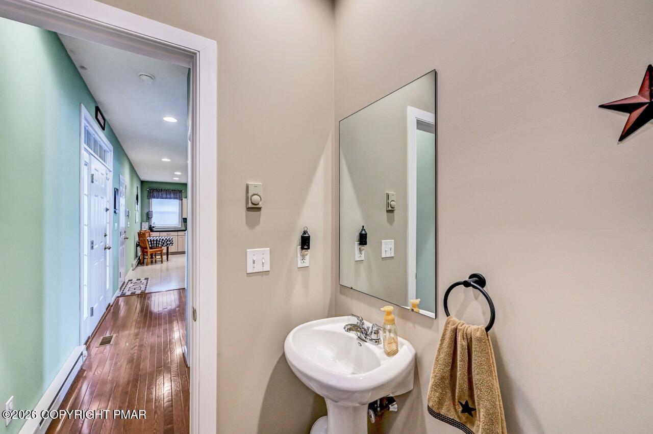 151 Skytop Road Long Pond, PA 18334 - Photo 14 of 36 a bathroom with a sink and a mirror