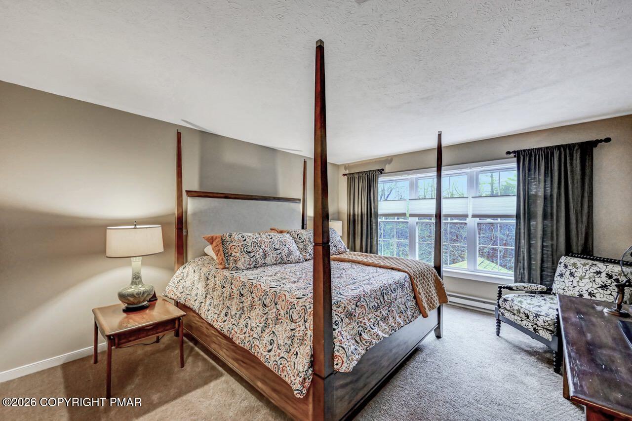 151 Skytop Road Long Pond, PA 18334 - Photo 18 of 36 a bedroom with a bed and large window