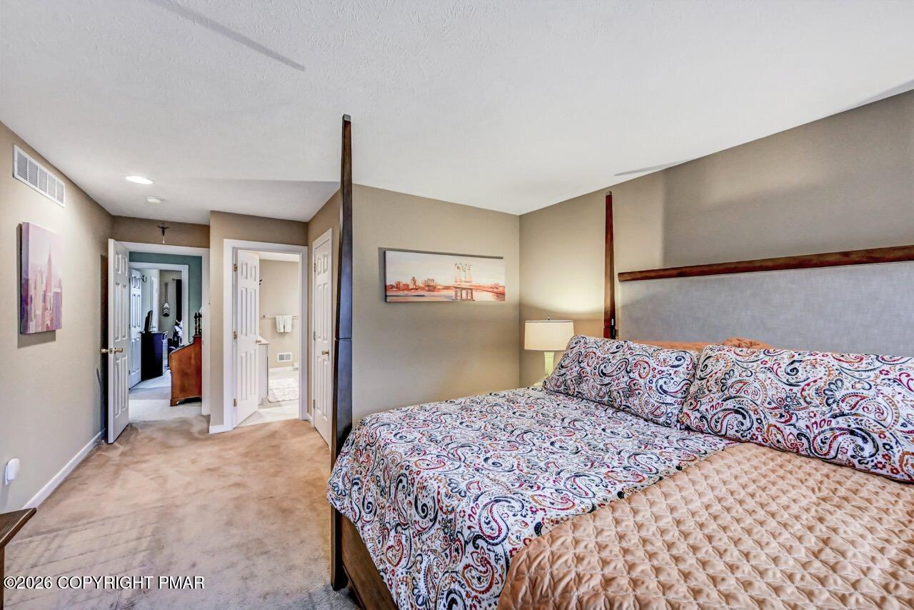 151 Skytop Road Long Pond, PA 18334 - Photo 19 of 36 a bedroom with a large bed and a closet