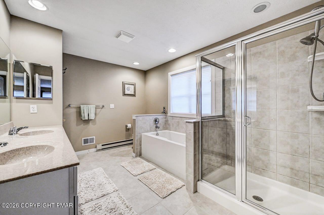 151 Skytop Road Long Pond, PA 18334 - Photo 20 of 36 a bathroom with a tub sink mirror and shower