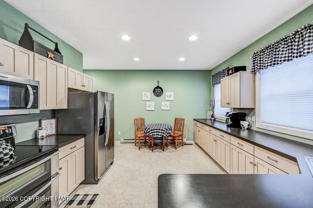 151 Skytop Road Long Pond, PA 18334 - Photo 9 of 36 a kitchen with stainless steel appliances granite countertop a refrigerator a stove top oven a sink and dishwasher