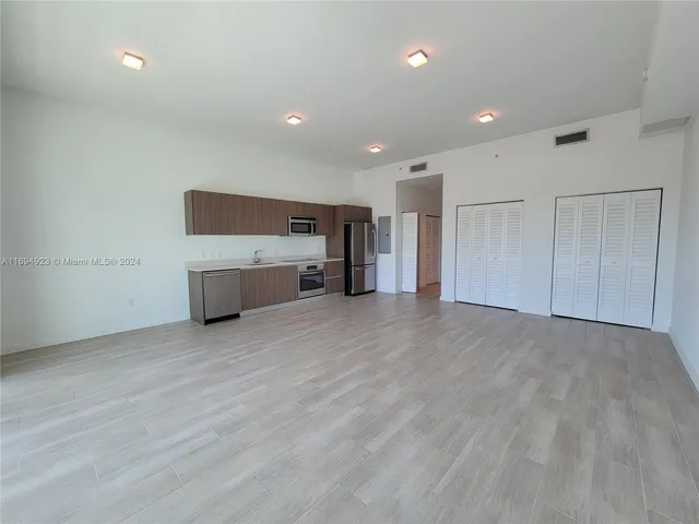 a view of empty room with a fireplace