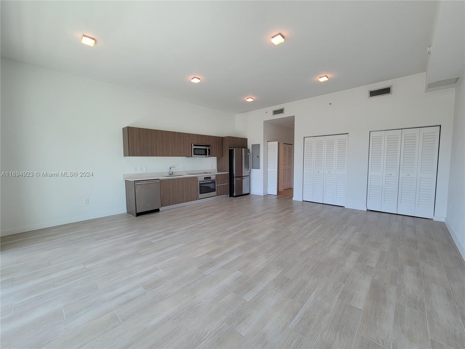 1600 Southwest 1st Avenue, Unit 411 Miami, FL 33129 - Photo 4 of 15 a view of empty room with a fireplace