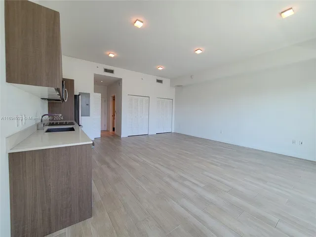 a view of kitchen appliances and wooden floor