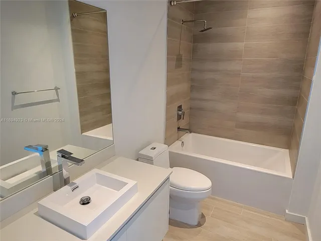 a bathroom with a sink a toilet and a bathtub