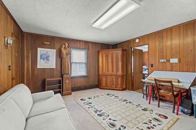 a bedroom with furniture and a wooden floor