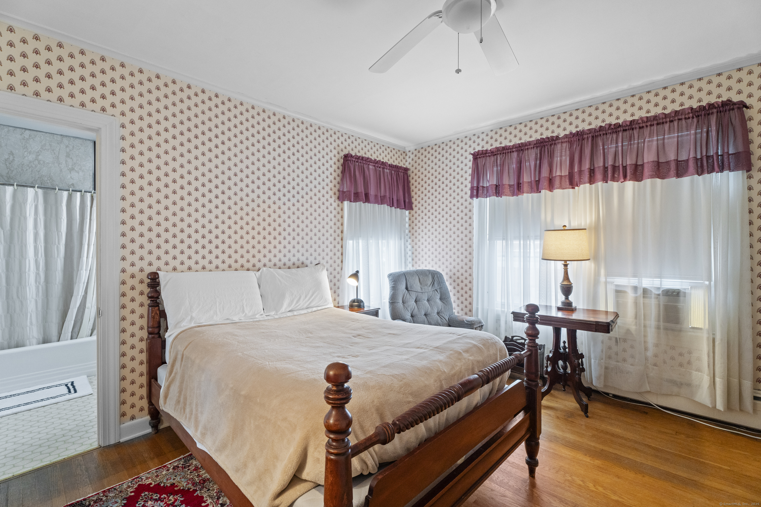 32 East Main Street Mystic, CT 06355 - Photo 24 of 40 a bedroom with a bed and a table