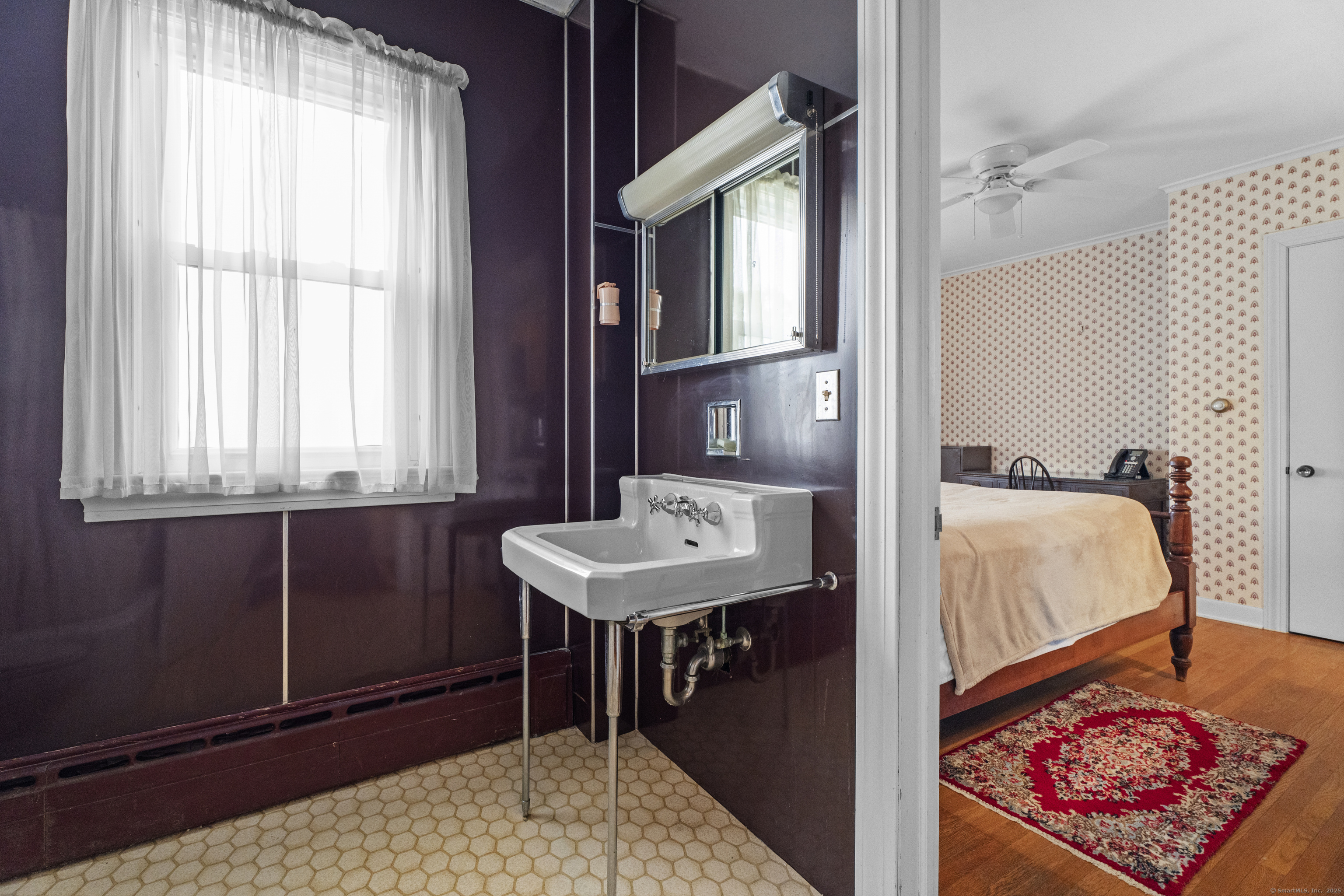 32 East Main Street Mystic, CT 06355 - Photo 25 of 40 a bedroom with a bed and a dresser next to a window