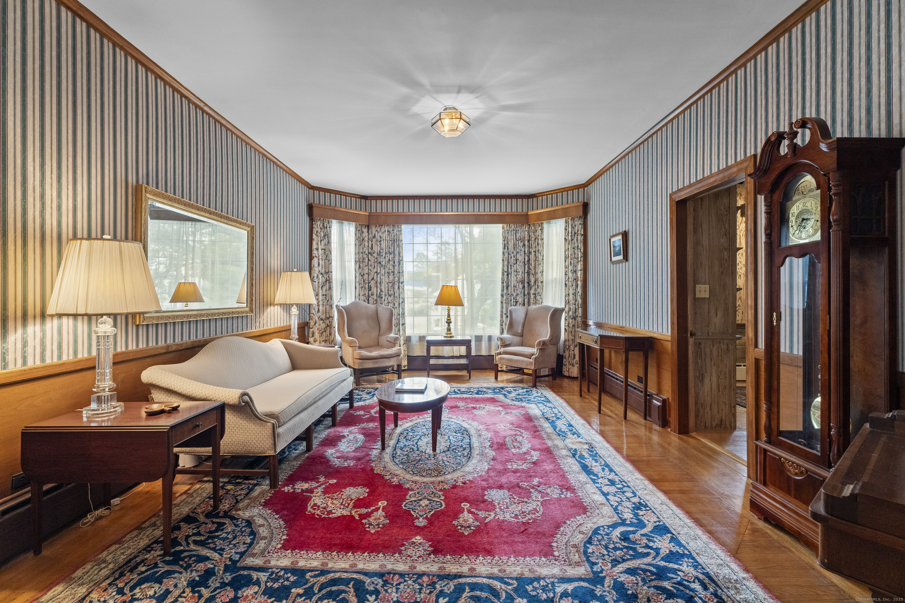 32 East Main Street Mystic, CT 06355 - Photo 3 of 40 a living room with furniture a rug and a large window