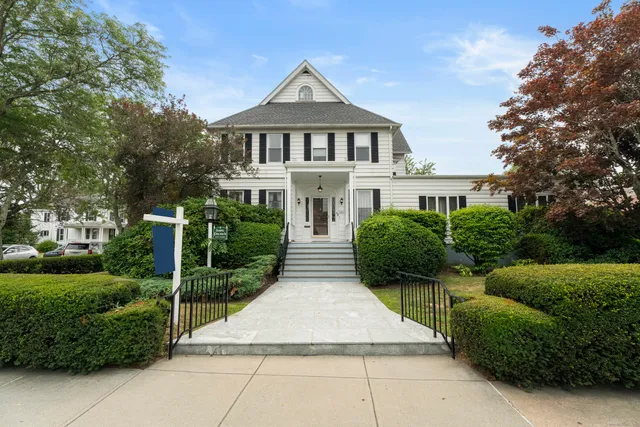 a front view of house with yard and green space