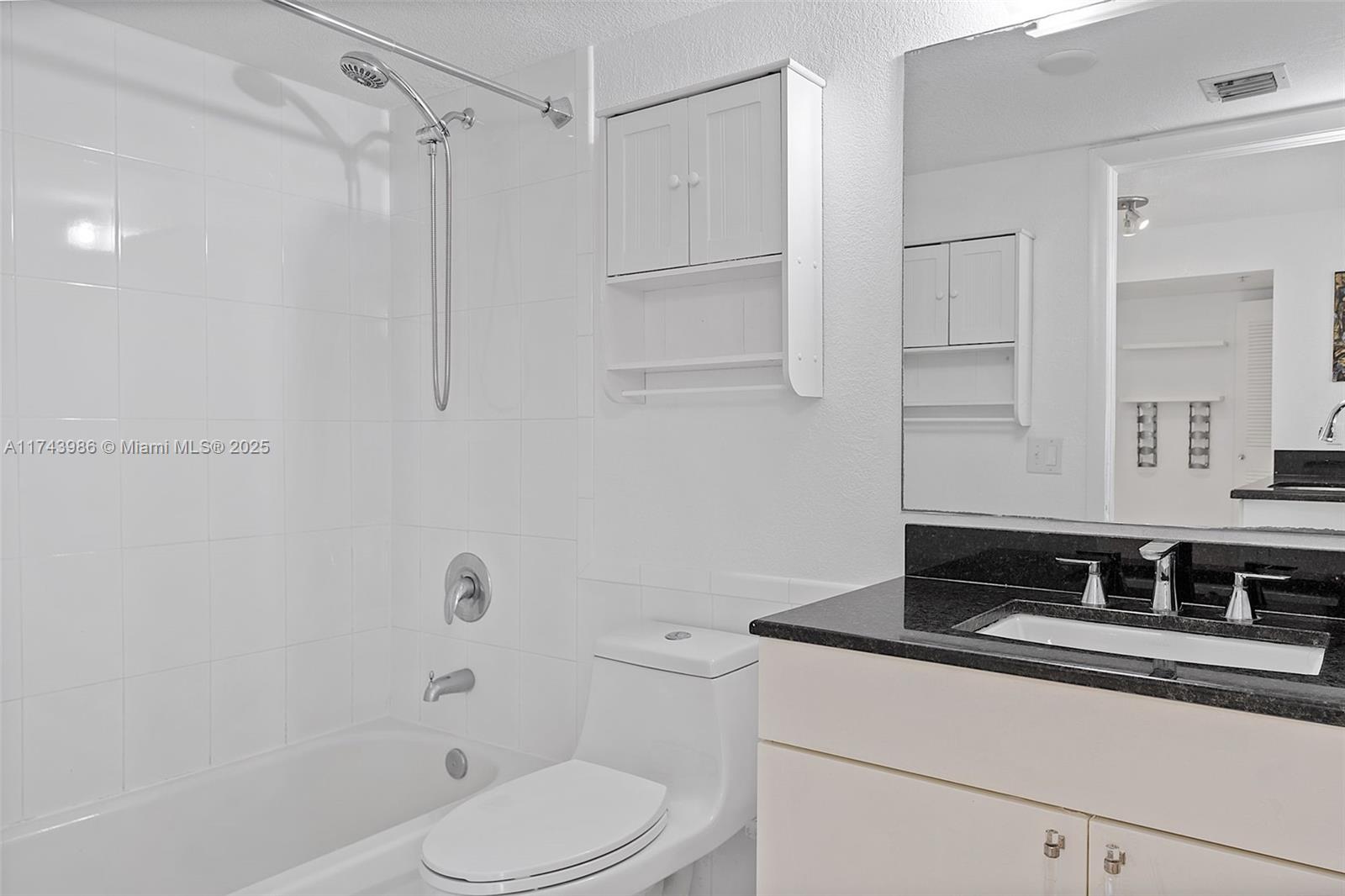 219 Northwest 12th Avenue, Unit 809 Miami, FL 33128 - Photo 14 of 32 a bathroom with a sink toilet vanity and shower