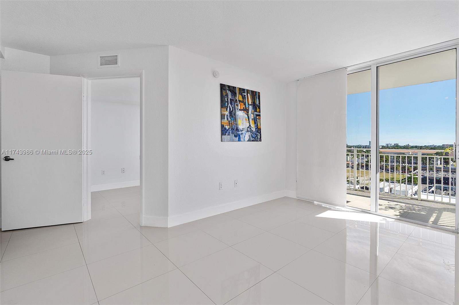 219 Northwest 12th Avenue, Unit 809 Miami, FL 33128 - Photo 7 of 32 a view of an empty room with a balcony