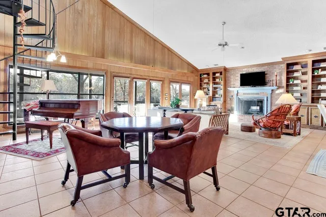 a living room with furniture a flat screen tv and a large window
